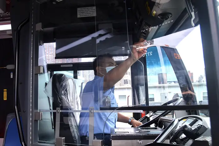 Bus driver slides his new window across